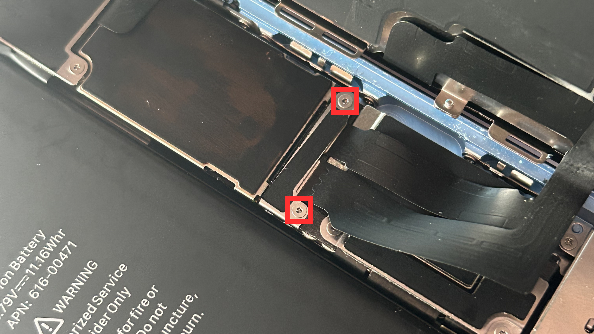 Close-up of the second metal shield and the two screws holding it in place