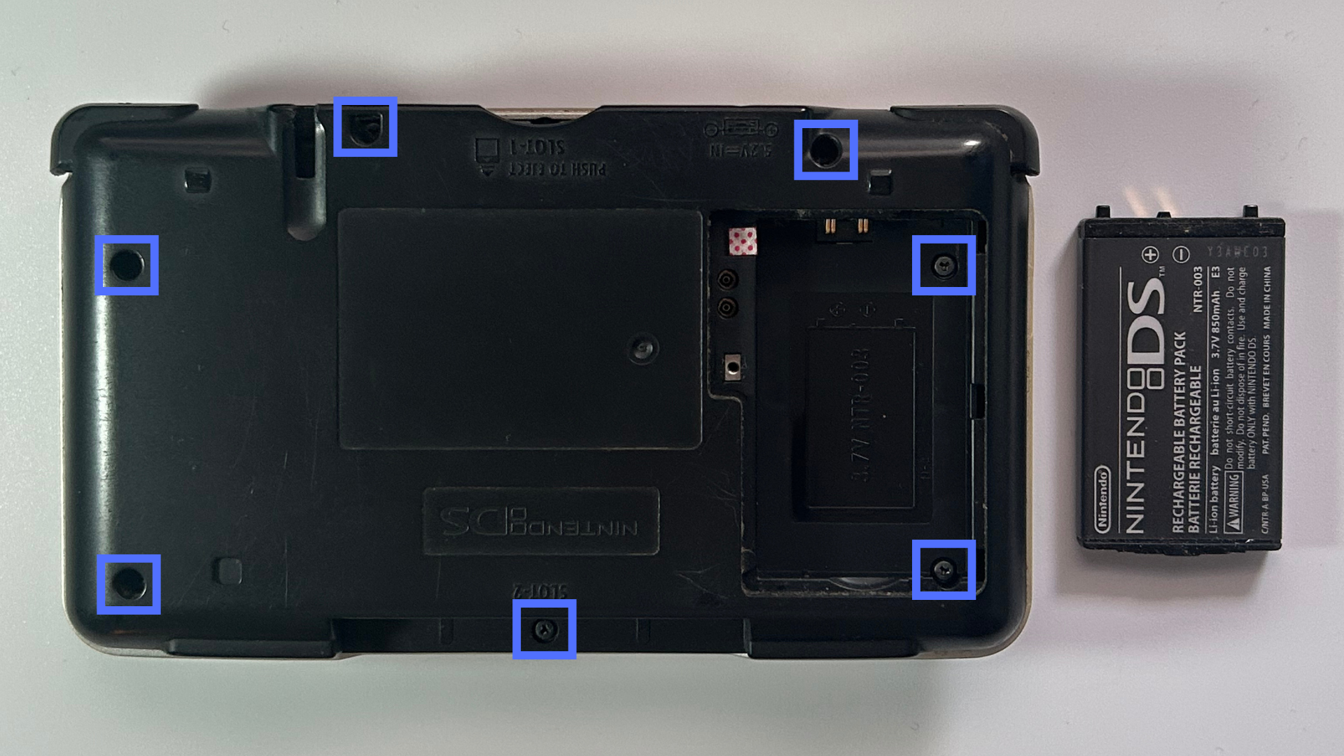 Original Nintendo DS battery removed from the rear compartment