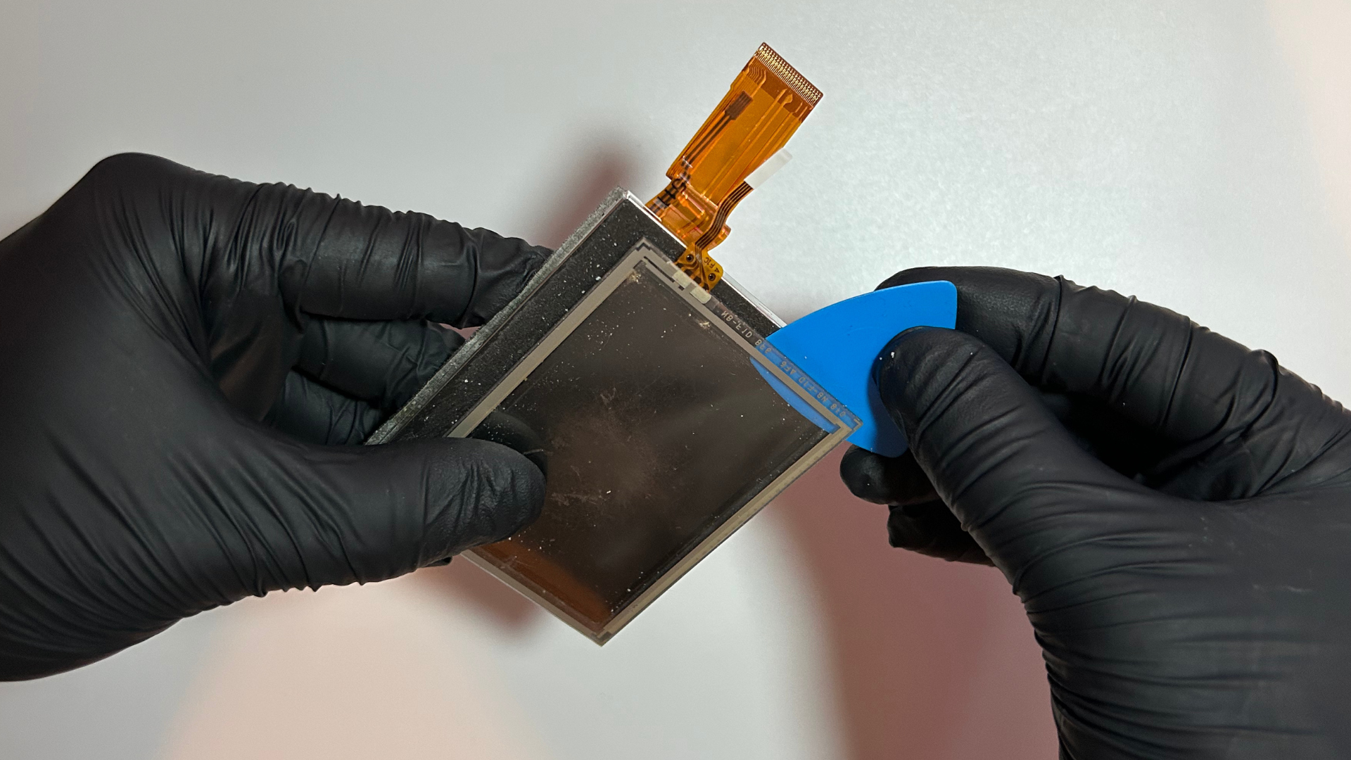 Touchscreen digitizer being separated from an original Nintendo DS bottom LCD