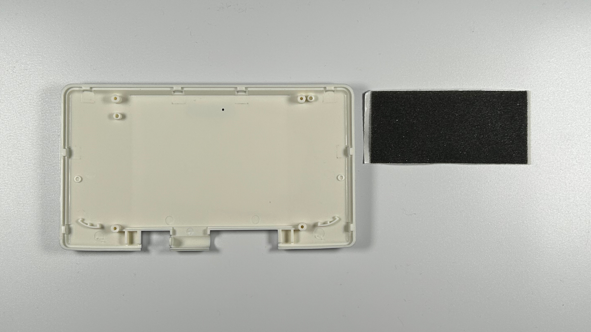 Replacement Nintendo DS shell pieces laid out ready for reassembly