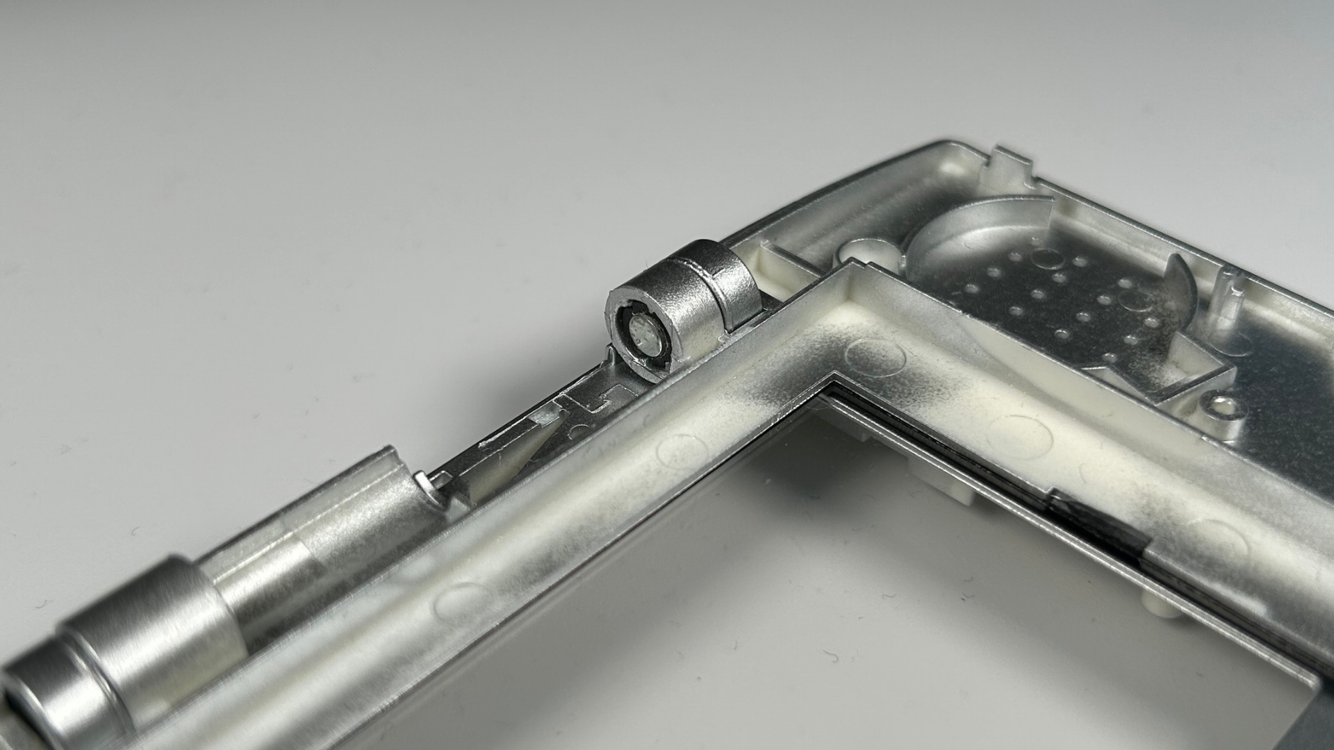 First hinge piece pushed fully into the replacement shell hinge section