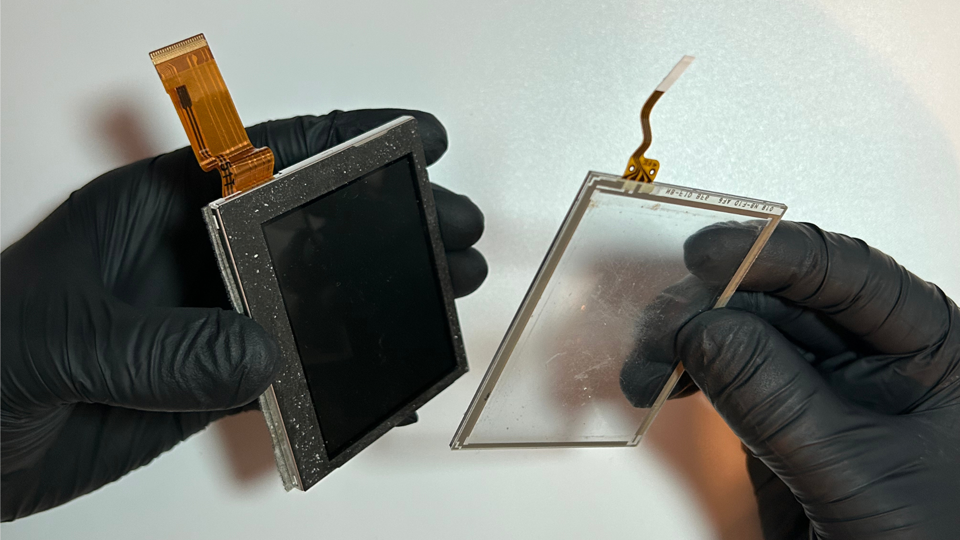 Plastic pick separating the Nintendo DS digitizer adhesive from the LCD