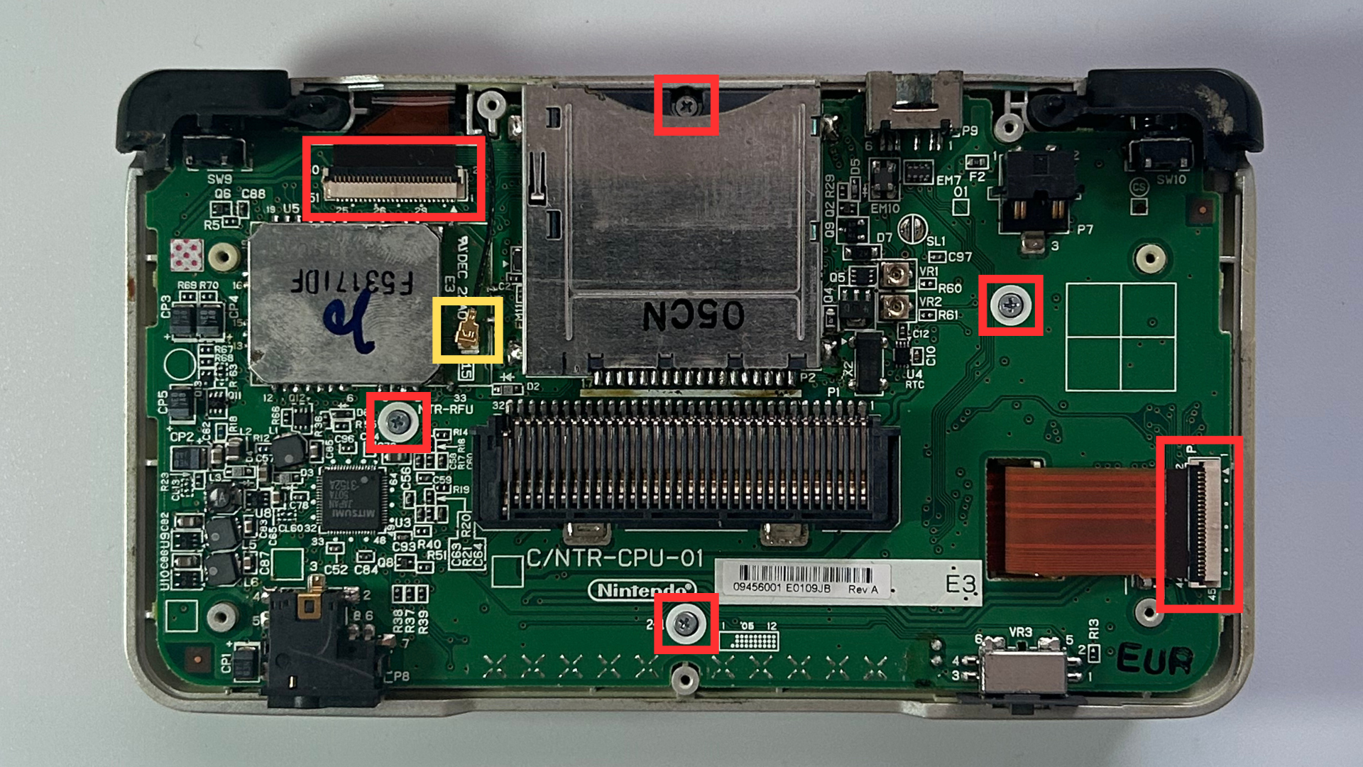 Original Nintendo DS with rear shell removed showing the motherboard