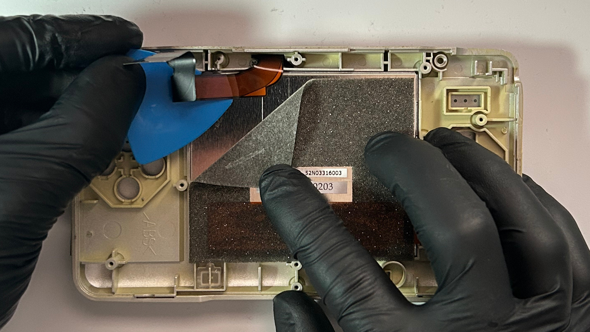 Bottom LCD inside an original Nintendo DS during removal