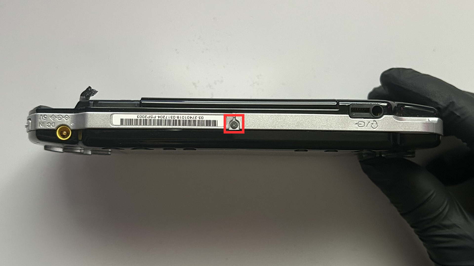 Screw on the bottom edge of the Sony PSP 2000