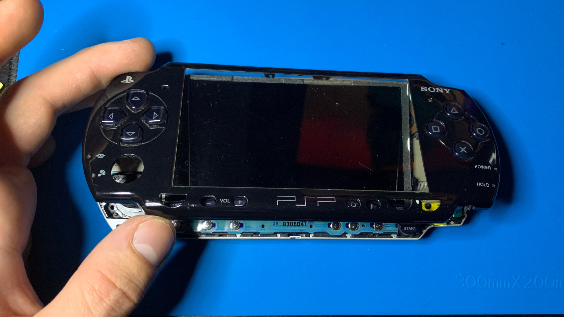 PSP 2000 with front faceplate removed and internal buttons exposed